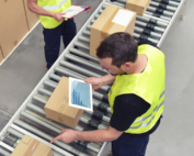 man checking parcels on iPad