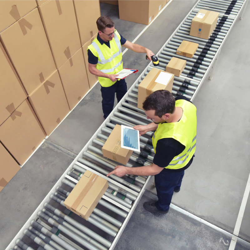 two warehouse workers scanning parcels