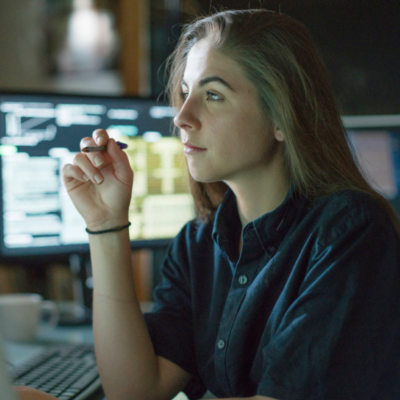 woman sat in office concentrating on computer