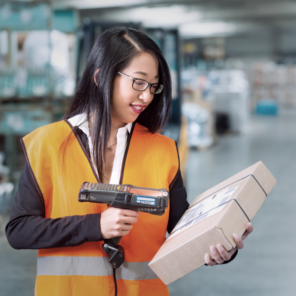 woman scanning parcel in warehouse