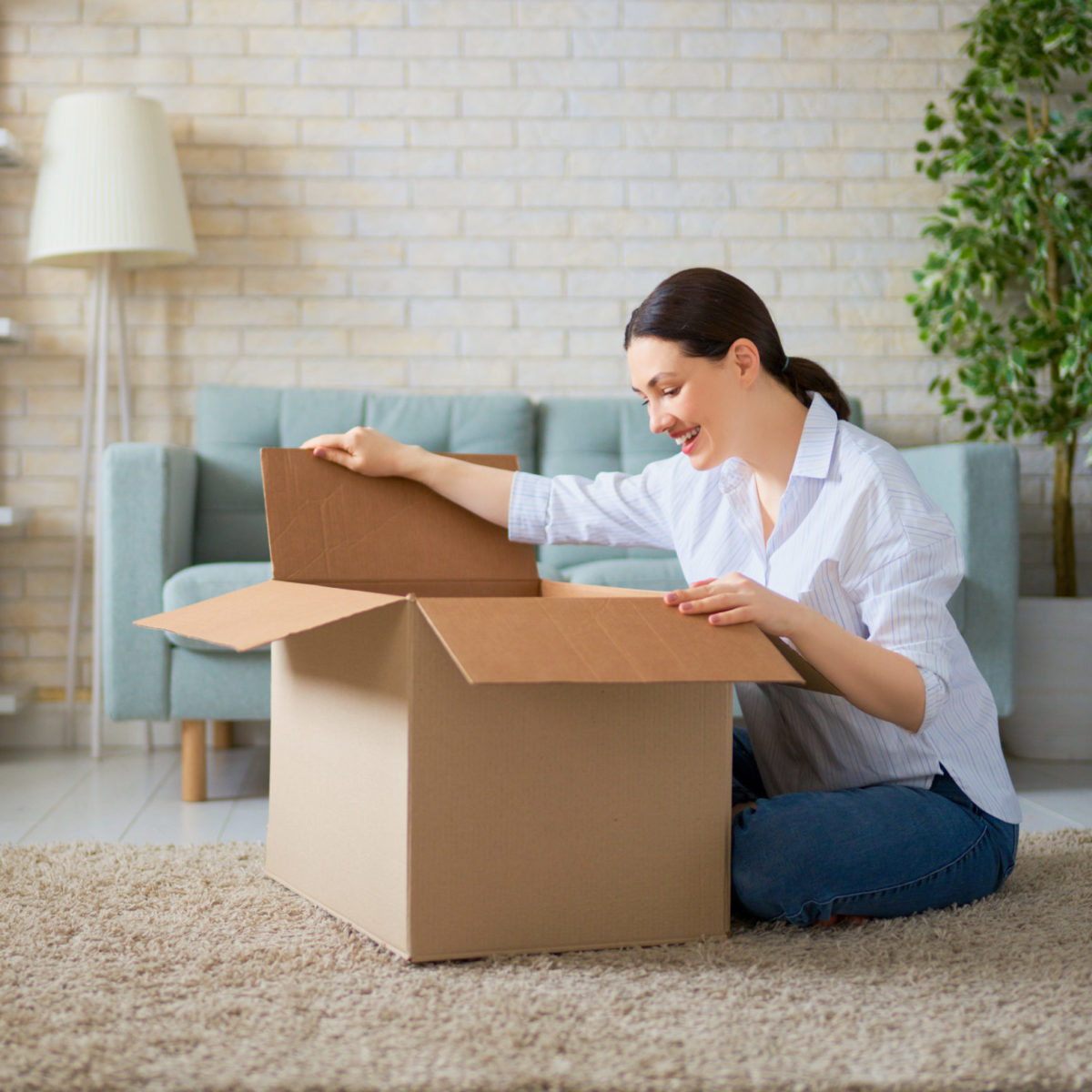 woman opening a box happy