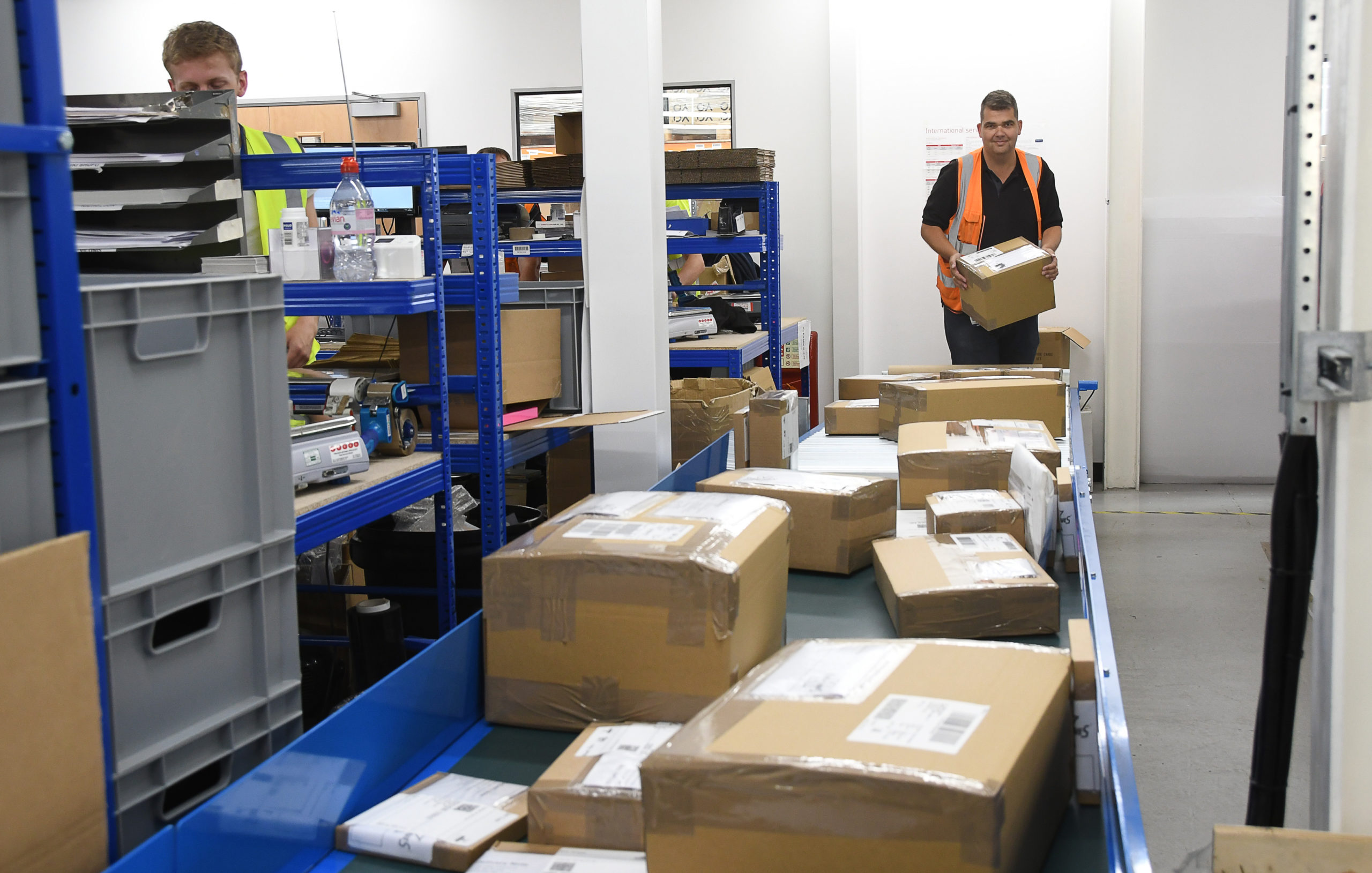 man sorting through parcels in warehouse