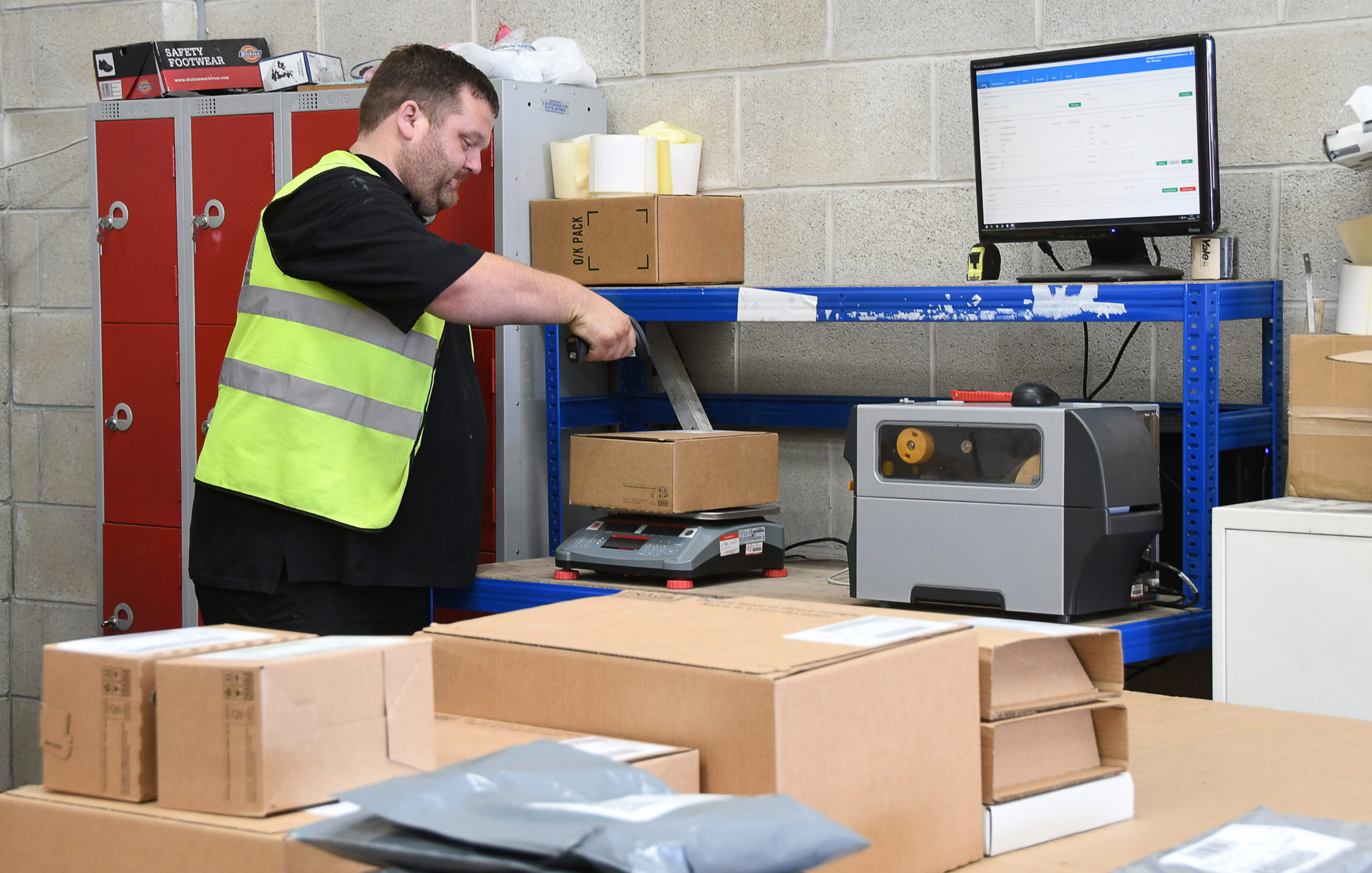 man weighing and scanning a parcel