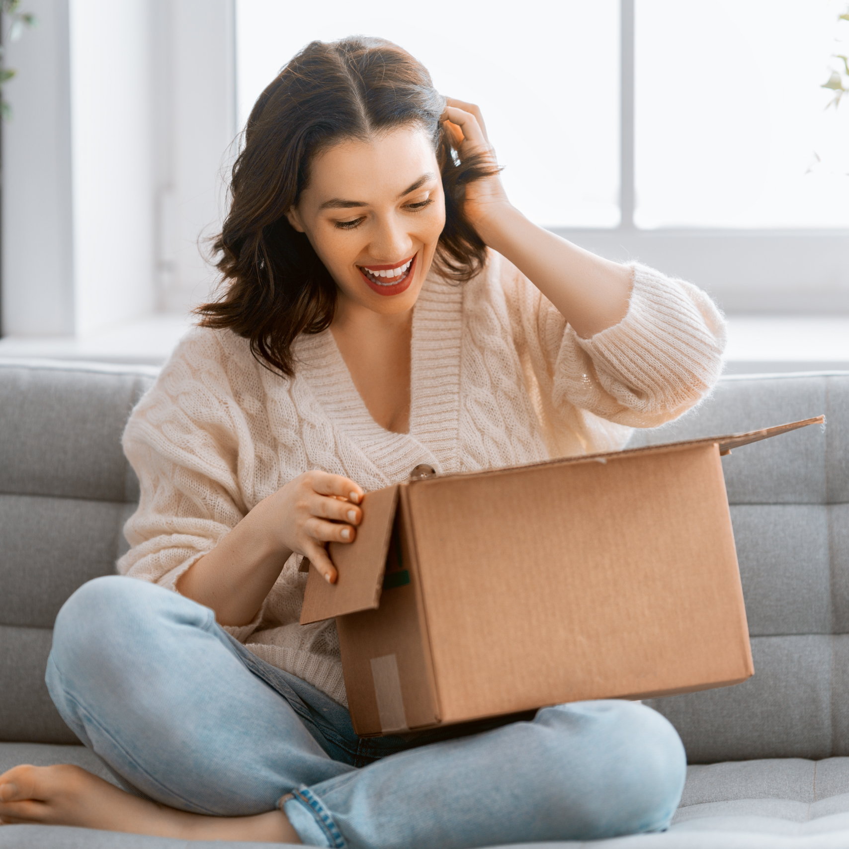 woman opening a parcel happily